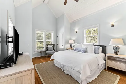 a bedroom with a large bed and a flat screen tv