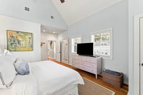 a bedroom with a bed and a flat screen tv