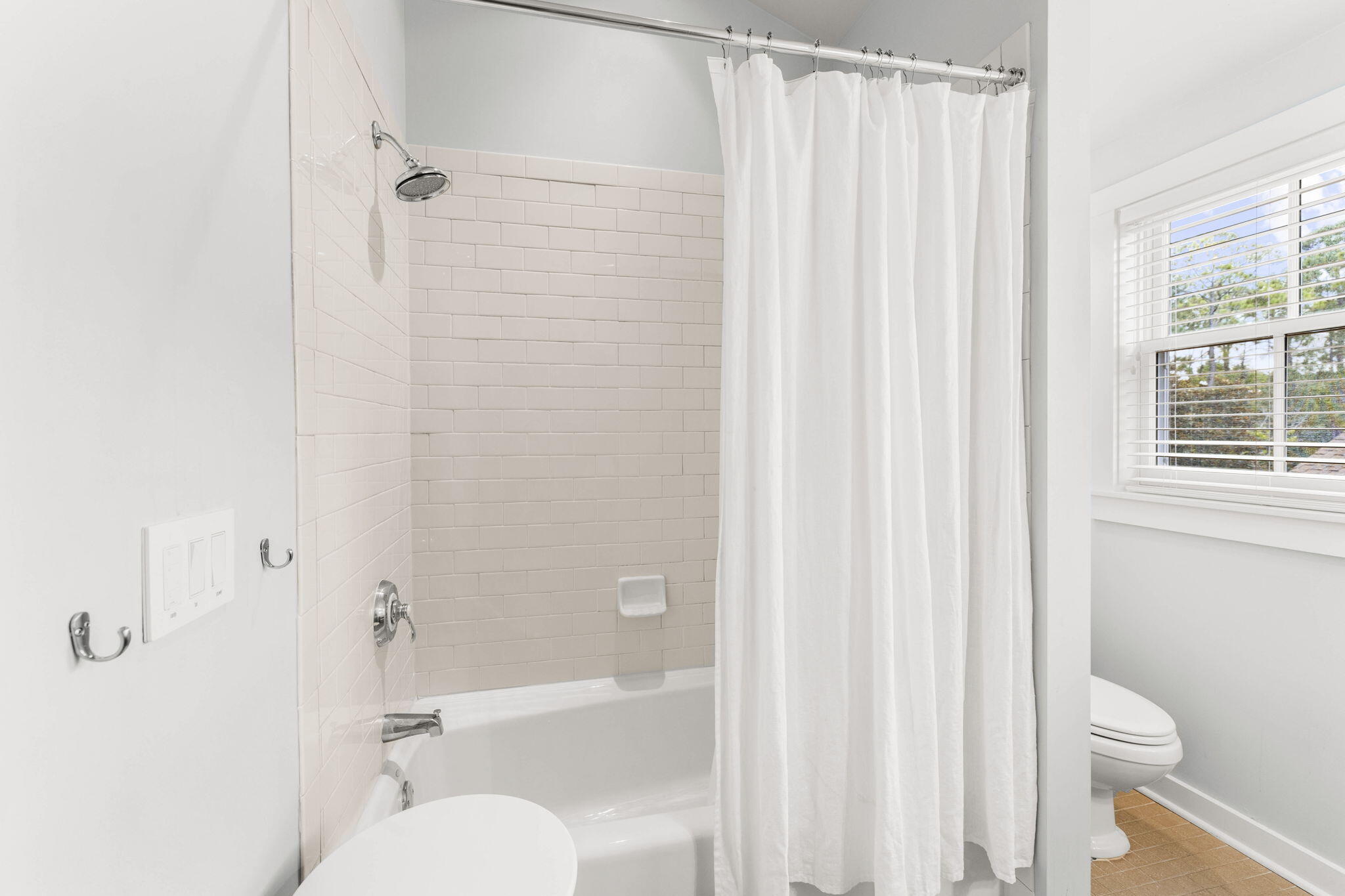 253 Salt Lane Watersound, FL 32461 - Photo 26 of 45 a bathroom with a toilet and a shower curtain