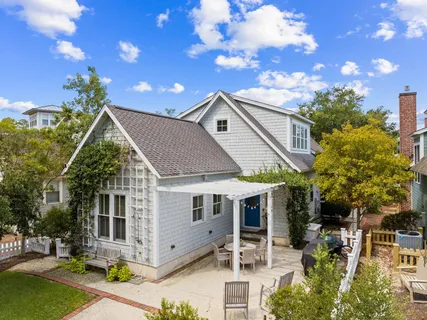 a view of a house with glass windows and plants