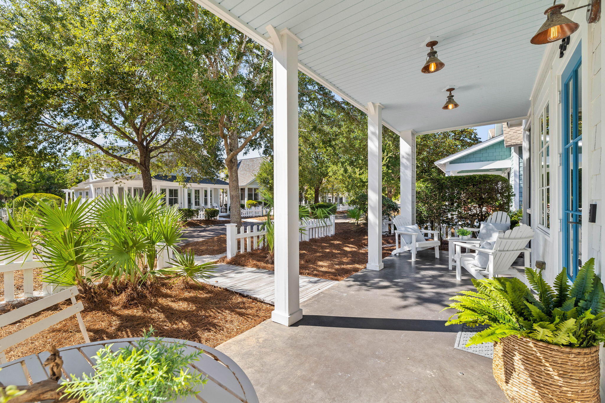 253 Salt Lane Watersound, FL 32461 - Photo 6 of 45 a view of a porch with chairs and potted plants