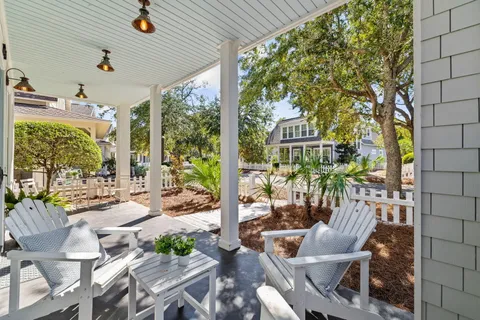 a view of a patio with couches table and chairs and potted plants