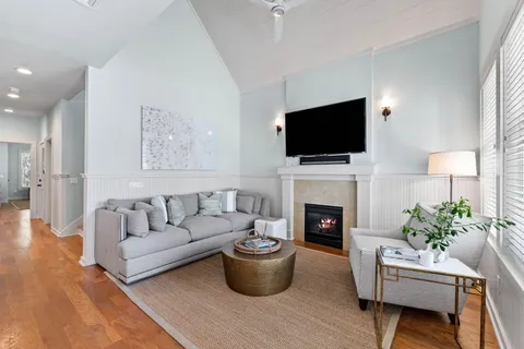 a living room with furniture a flat screen tv and a fireplace
