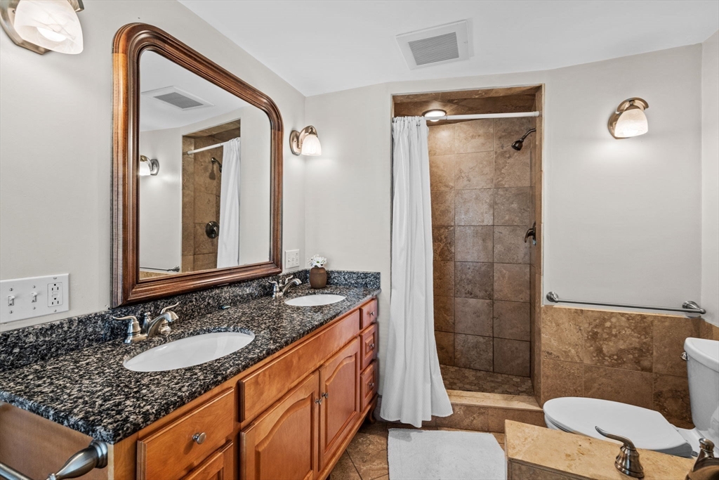 5 Orchard Circle Marblehead, MA 01945 - Photo 17 of 36 a bathroom with a sink a toilet and shower