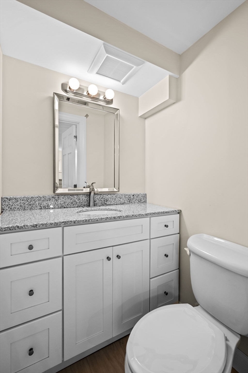 5 Orchard Circle Marblehead, MA 01945 - Photo 25 of 36 a bathroom with a granite countertop toilet sink and mirror