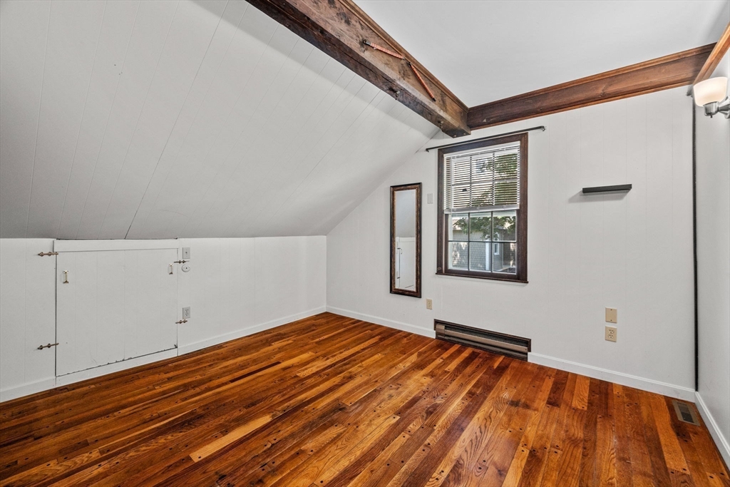 5 Orchard Circle Marblehead, MA 01945 - Photo 30 of 36 a view of an empty room with window and wooden floor