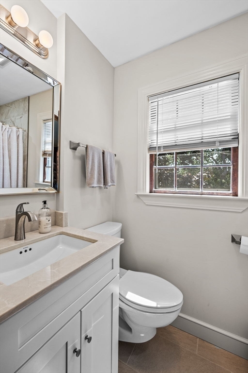5 Orchard Circle Marblehead, MA 01945 - Photo 31 of 36 a bathroom with a toilet a sink a mirror and a window