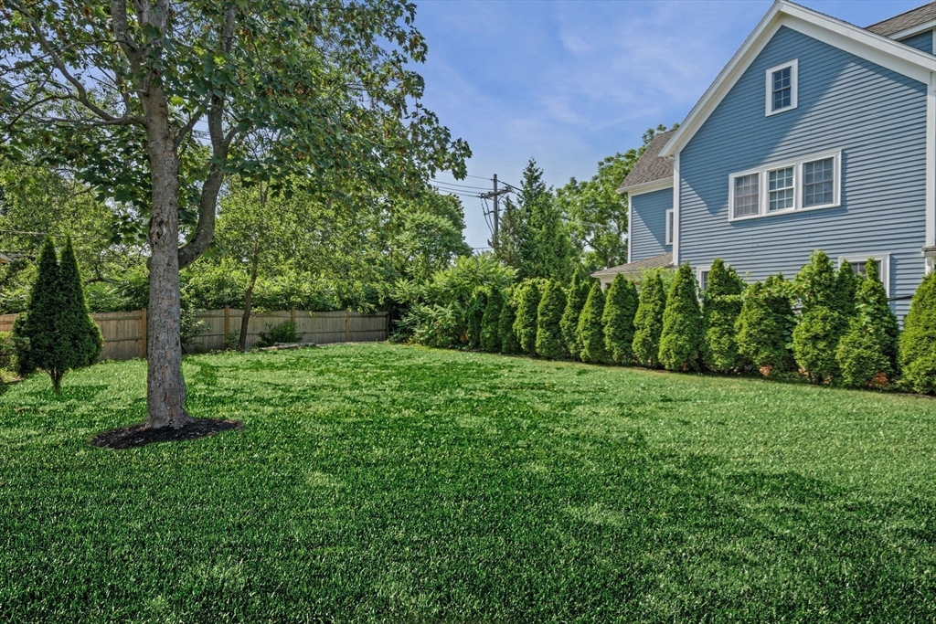 5 Orchard Circle Marblehead, MA 01945 - Photo 4 of 36 a view of a backyard with plants and large trees