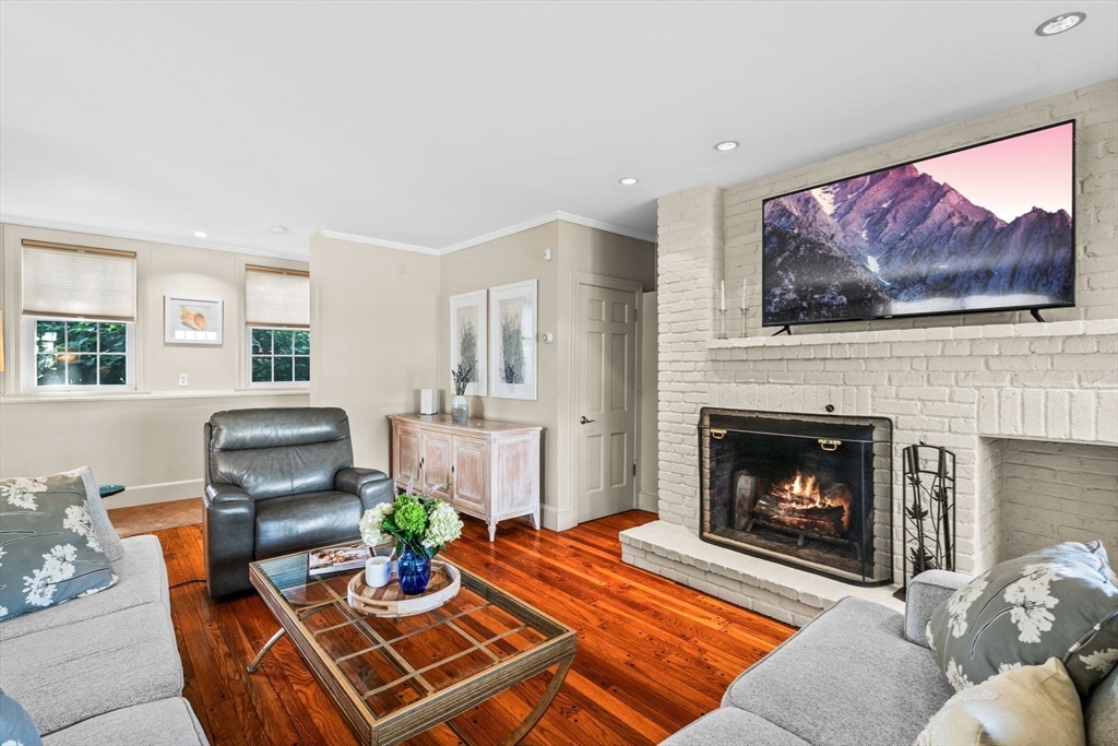 5 Orchard Circle Marblehead, MA 01945 - Photo 8 of 36 a living room with furniture a flat screen tv and a fireplace