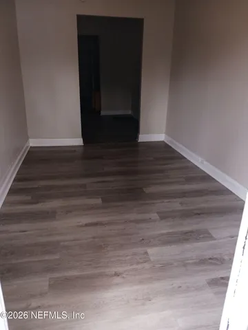 a view of a small space with wooden floor