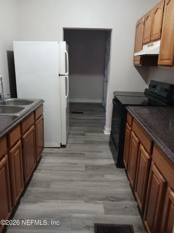 a view of a kitchen from the hallway