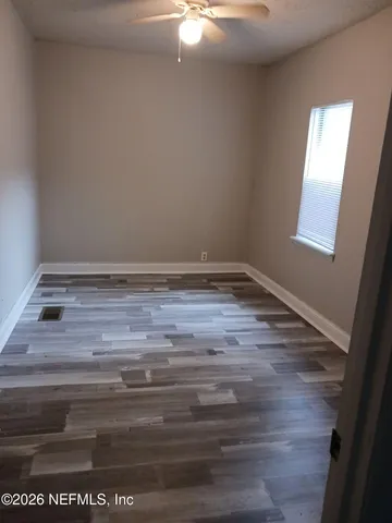 a view of room with window and hardwood floor
