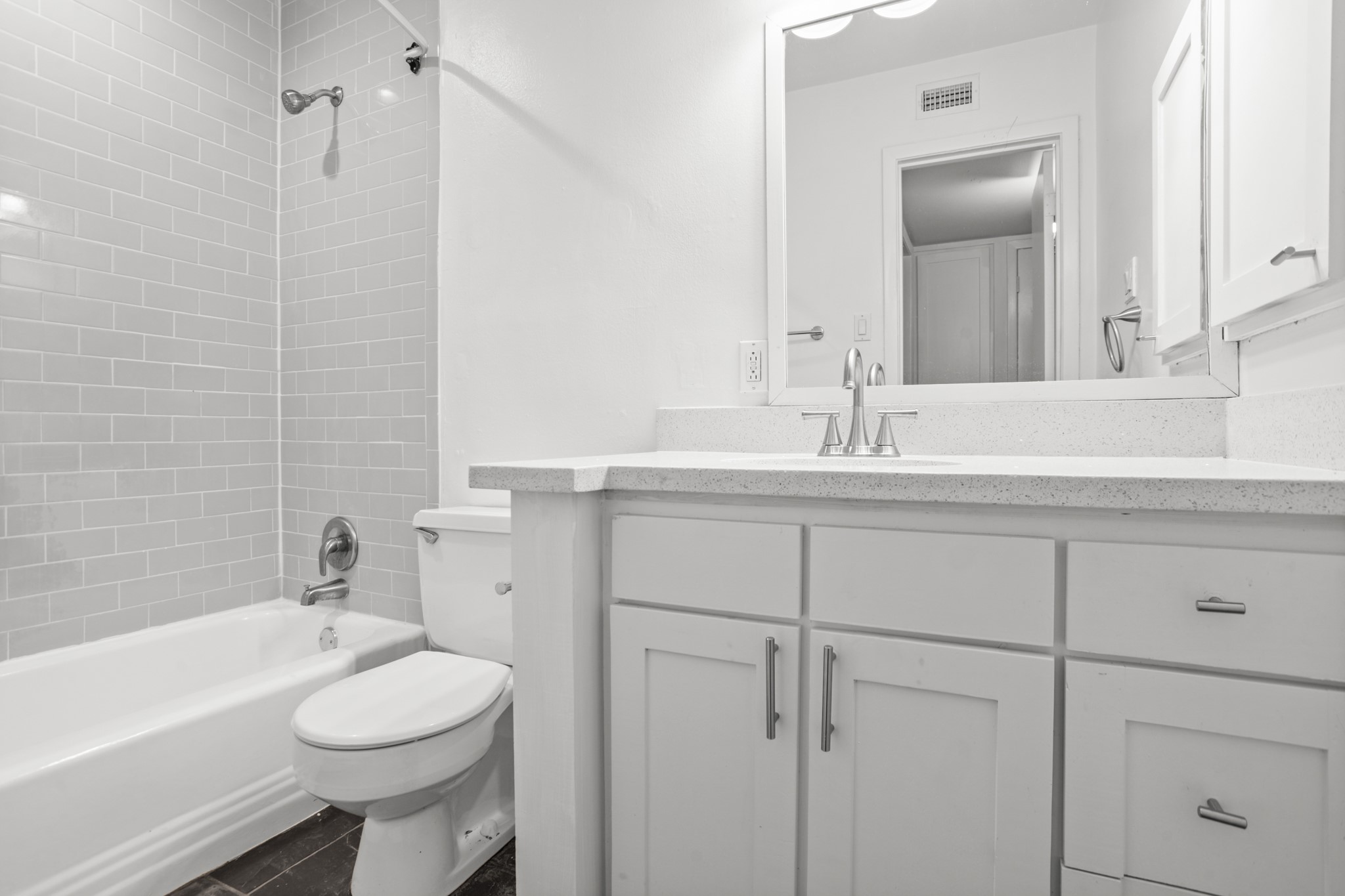 3602 Garrott Street, Unit 3 Houston, TX 77006 - Photo 24 of 34 The remodeled bath has a tub shower combo with slate floors.