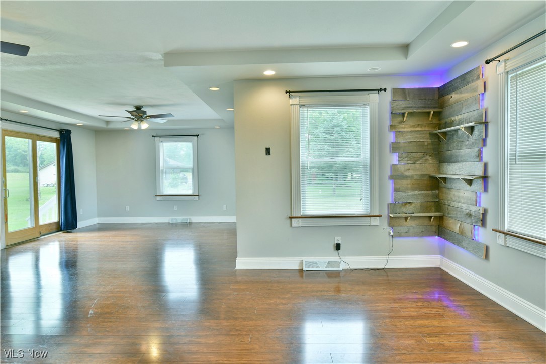 1735 Pleasant Valley Road Girard, OH 44420 - Photo 13 of 44 Spare room with wood finished floors, a tray ceiling, a ceiling fan, and recessed lighting