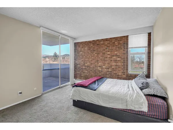 a bedroom with a bed and a large mirror