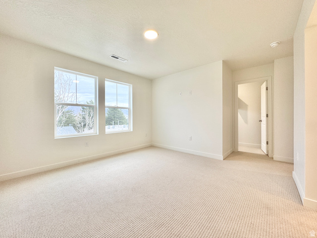 1650 North Main Street Layton, UT 84041 - Photo 16 of 24 Light-filled room featuring two large windows, neutral carpet, recessed lighting, and white baseboards
