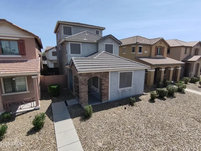 a view of a house with a yard and sitting space