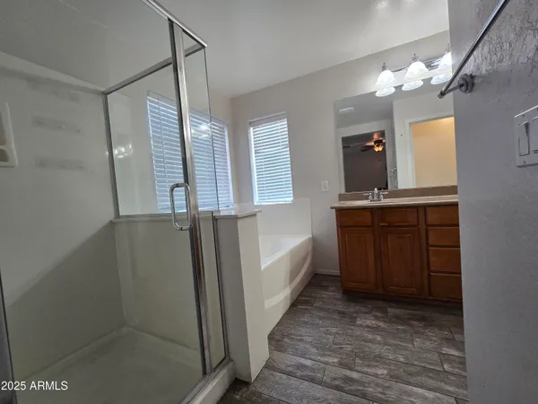 a view of a kitchen with kitchen island a sink stainless steel appliances and cabinets