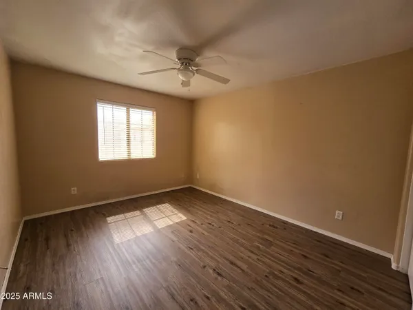 a bathroom with a granite countertop sink toilet and a mirror