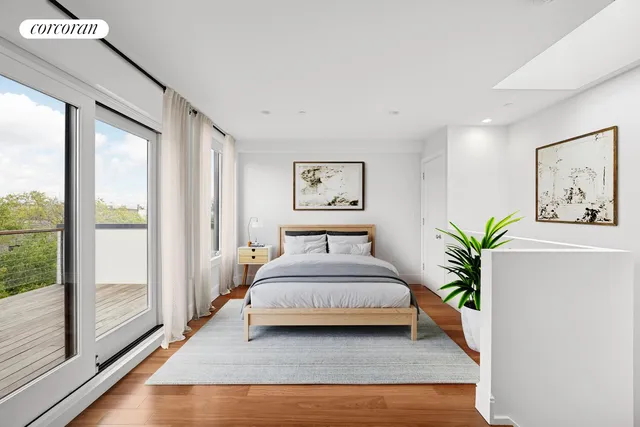 a bedroom with a bed and a large window