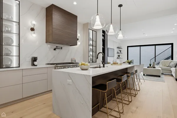 a kitchen with stainless steel appliances granite countertop a sink a stove and a wooden floors