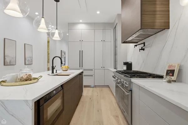 a bathroom with a granite countertop toilet sink and mirror