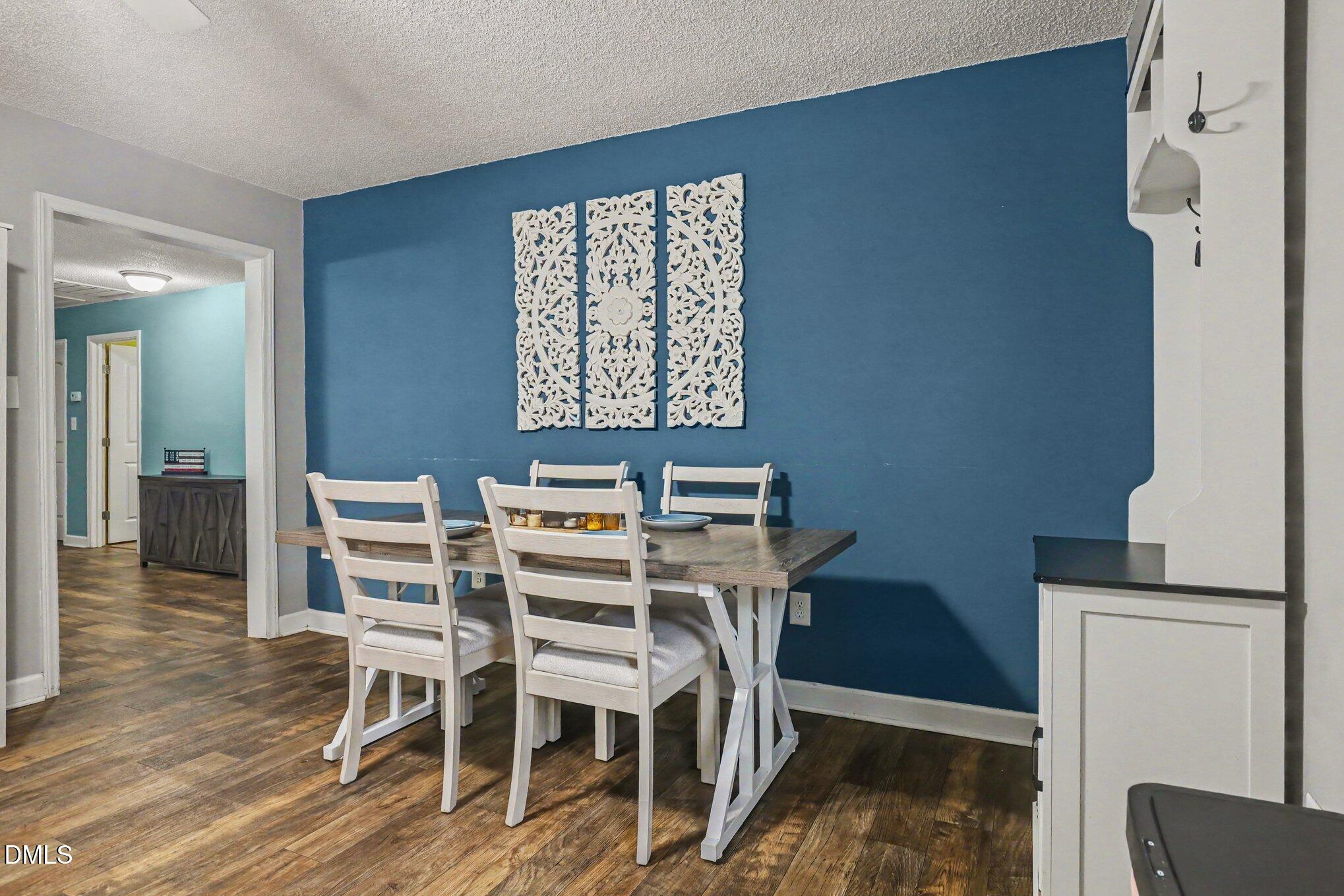 977 Stevens Mill Road Goldsboro, NC 27530 - Photo 9 of 31 a view of a dining room with furniture and wooden floor