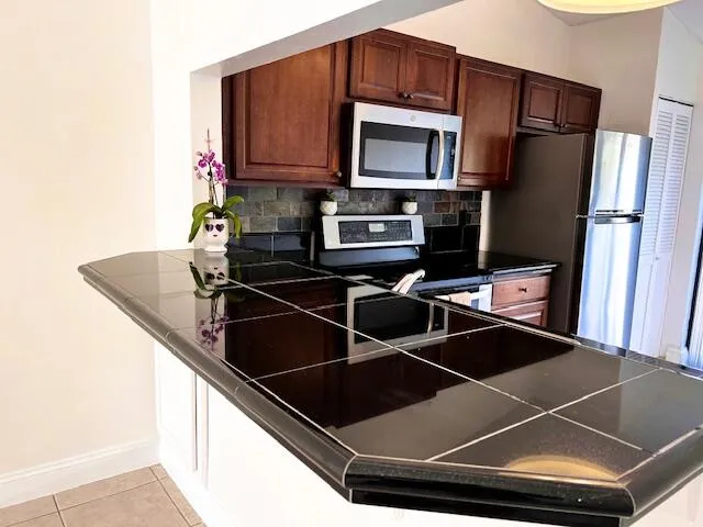 a kitchen with a sink cabinets and stainless steel appliances