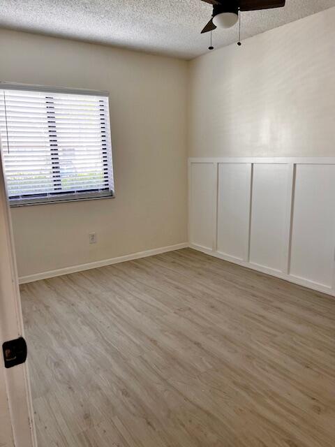 10323 Boca Bend West, Unit K4 Boca Raton, FL 33428 - Photo 17 of 25 an empty room with wooden floor and windows