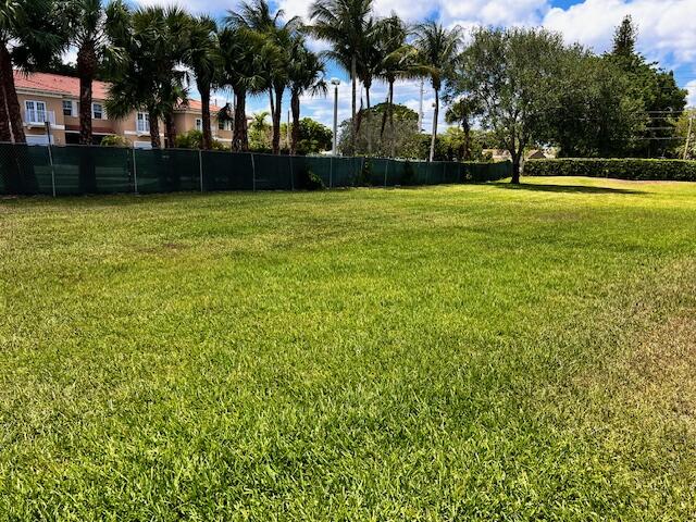 10323 Boca Bend West, Unit K4 Boca Raton, FL 33428 - Photo 24 of 25 a view of a swimming pool and trees in the background
