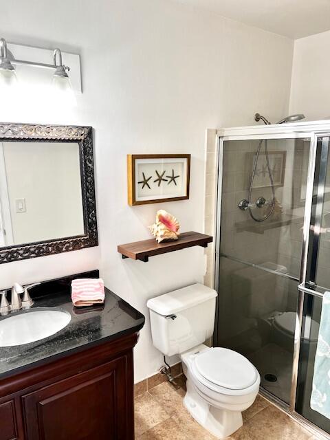 10323 Boca Bend West, Unit K4 Boca Raton, FL 33428 - Photo 9 of 25 a bathroom with a granite countertop toilet sink and mirror