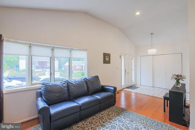 a view of a dining room and livingroom with furniture a rug a rug and a chandelier