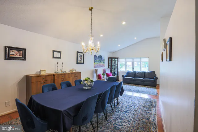 a living room with furniture a rug and a table