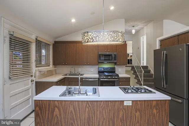 a kitchen with a refrigerator and a sink