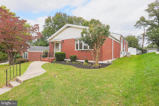 a view of a house with a yard and a garden
