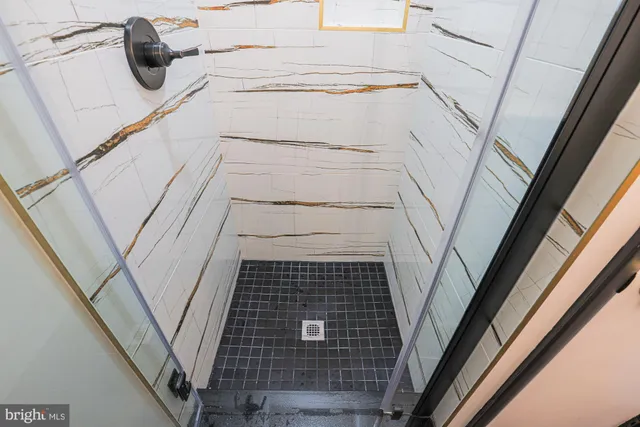 a bathroom with a toilet a sink and shower