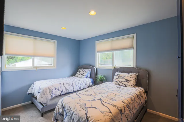 a living room with furniture and a book shelf