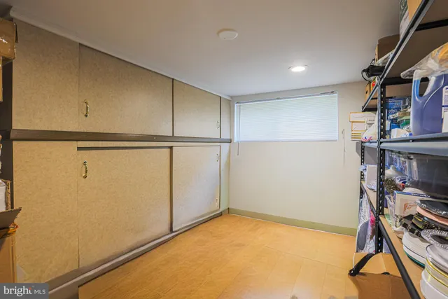 a backyard of a house with plants and large trees