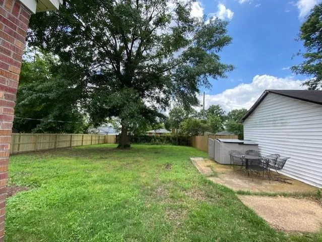 a view of a backyard with a garden and sitting area
