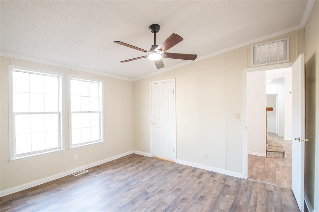 128 Fob Lane Frierson, LA 71027 - Photo 11 of 22 a view of empty room with wooden floor and fan