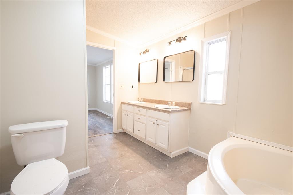 128 Fob Lane Frierson, LA 71027 - Photo 12 of 22 a bathroom with a toilet a sink and mirror