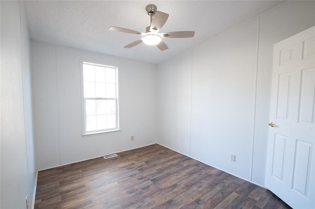 128 Fob Lane Frierson, LA 71027 - Photo 17 of 22 an empty room with wooden floor and windows