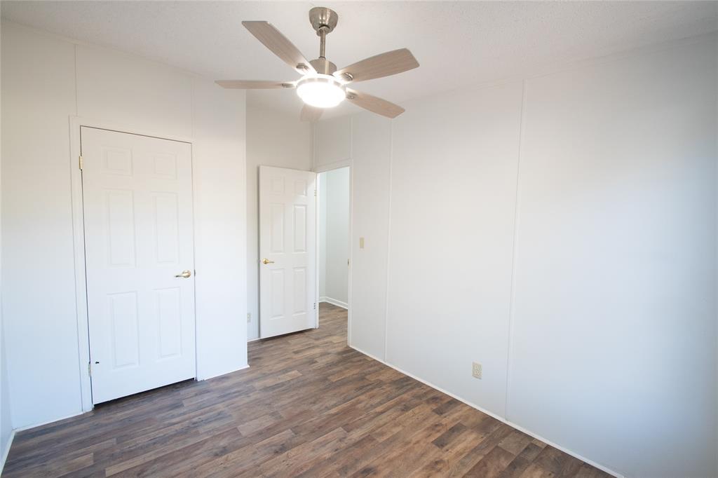 128 Fob Lane Frierson, LA 71027 - Photo 19 of 22 an empty room with wooden floor and fan