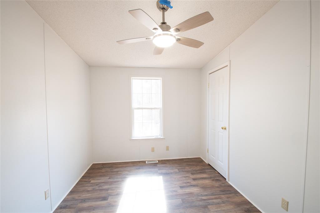 128 Fob Lane Frierson, LA 71027 - Photo 21 of 22 an empty room with wooden floor and windows