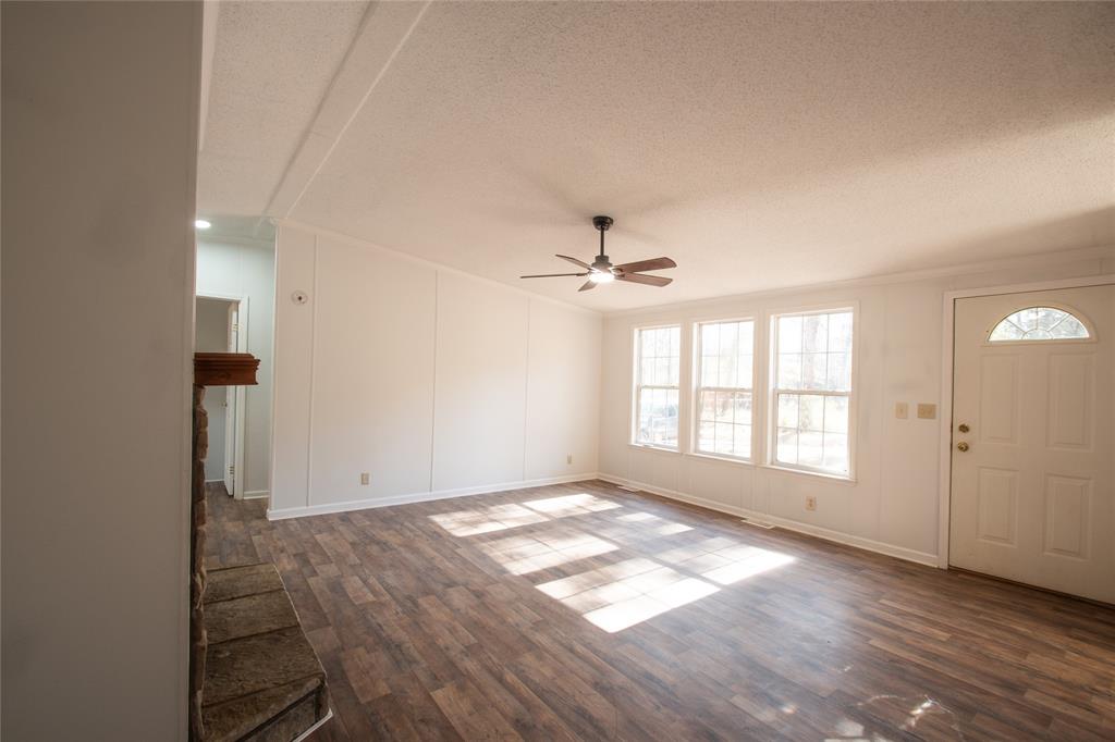 128 Fob Lane Frierson, LA 71027 - Photo 5 of 22 a view of empty room with wooden floor and fan