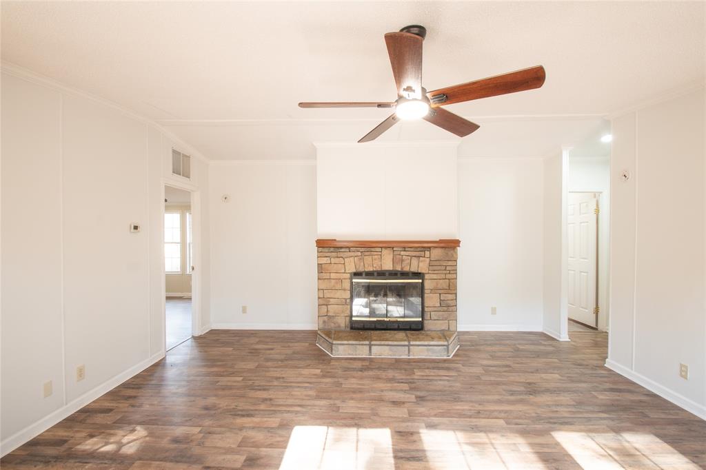 128 Fob Lane Frierson, LA 71027 - Photo 6 of 22 a view of empty room with wooden floor and fireplace