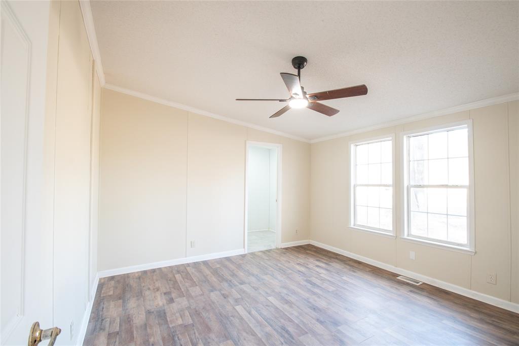128 Fob Lane Frierson, LA 71027 - Photo 10 of 22 an empty room with wooden floor and windows