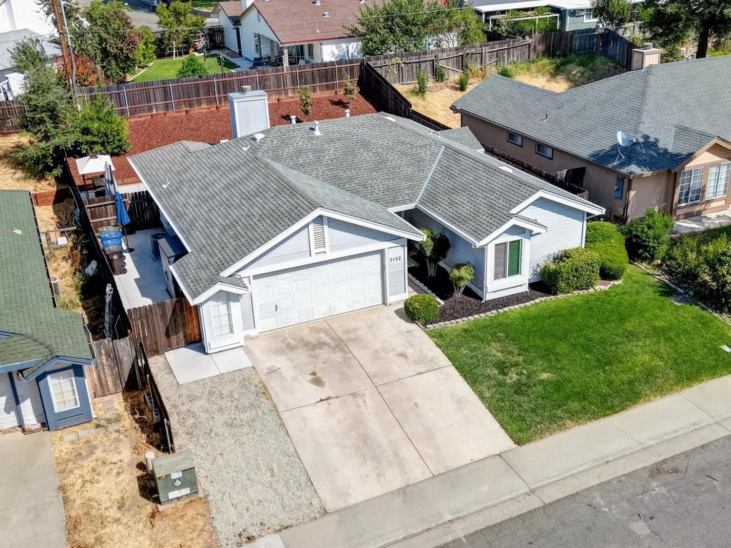 an aerial view of a house with a yard