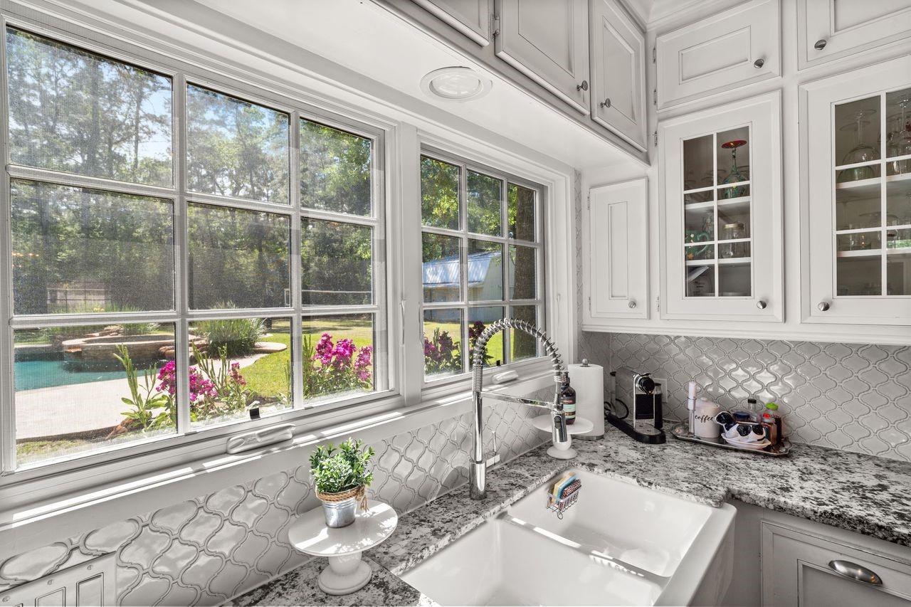 36 Wind River Drive Conroe, TX 77384 - Photo 23 of 45 Great memories to be made here while watching the family play in the yard. This kitchen has a stylish backsplash and a sleek, modern faucet energy efficient windows and plenty of storage.