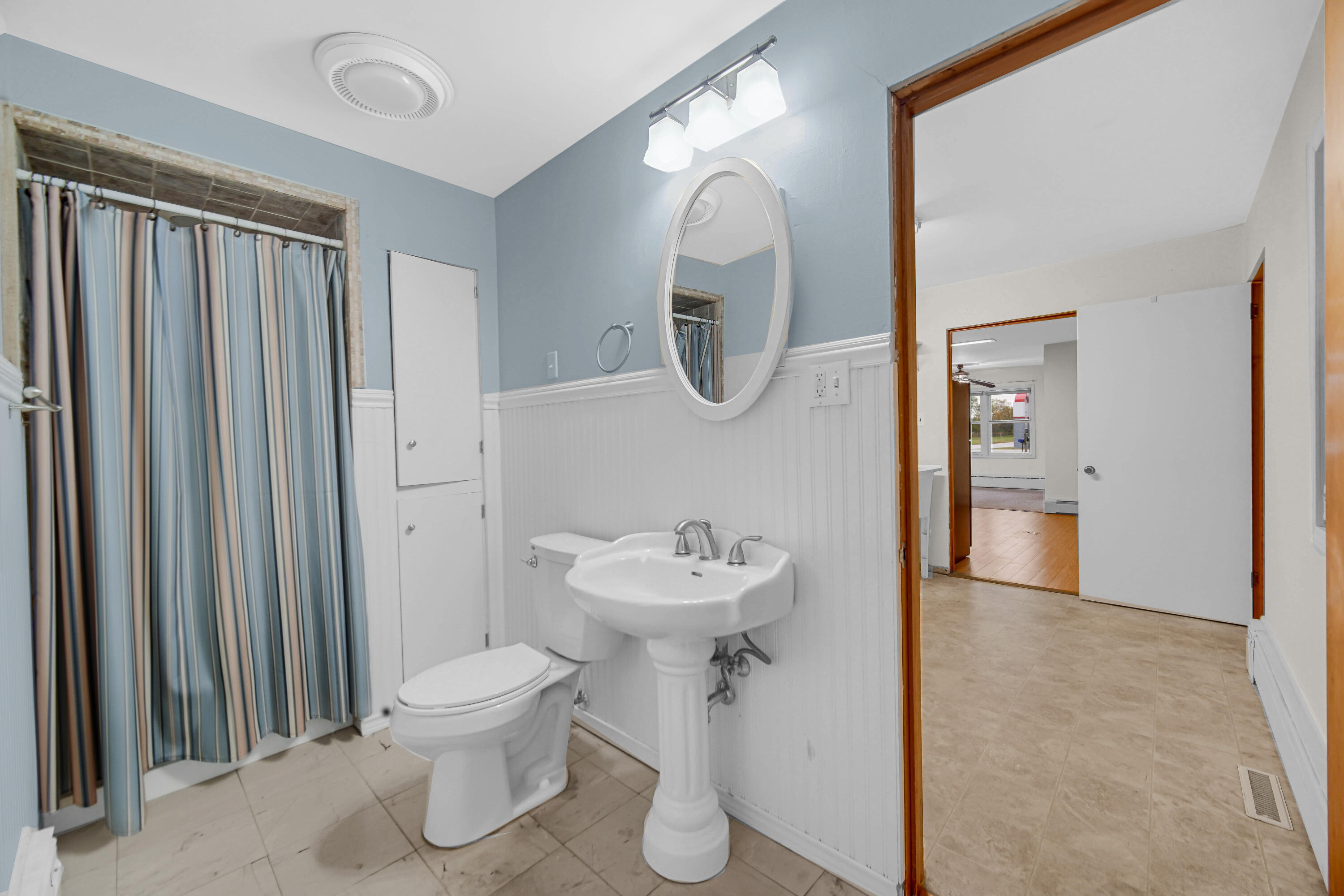 204 North Main Street Kouts, IN 46347 - Photo 4 of 28 a bathroom with a sink toilet and a mirror